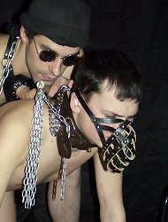 Gayboy slave worships the feet of the whip-wielding wildman!