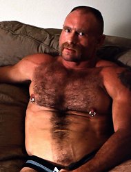 Hot gay bear hunk George strokes his pierced huge dick in the living room